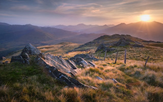 Grassy fence mountains sunset horizon - a grassy field free wallpaper