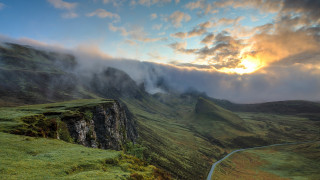 Mountain road clouds sunset mist - the background and a sun setting free wallpaper