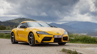 Yellow sports car mountains lake - a cloudy sky in the background free wallpaper
