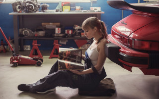 Woman sitting garage reading car - feminist free wallpaper