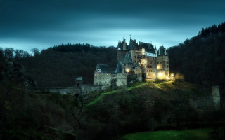 Castle lit night hill trees - a dark sky above free wallpaper