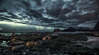 Cloudy beach lighthouse ocean mountains - rocky free wallpaper
