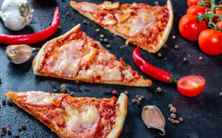 Pizza slices vegetables black surface - a pizza free wallpaper