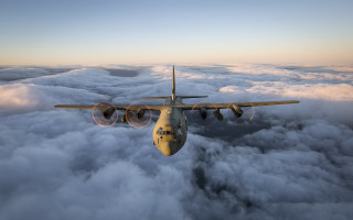 Airplane clouds sky mountains ocean - a large air plane free wallpaper