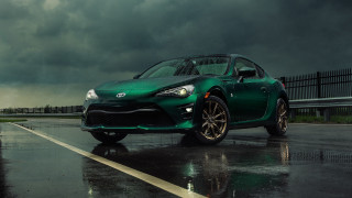 Green sports car wet road - a green sports car free wallpaper