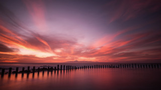 Sunset water fence mountains sky - a photo free wallpaper