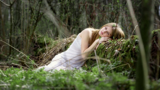 Woman lying woods dreamlike white - the wood free wallpaper