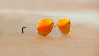 Sunglasses beach ocean sand sky - a reflection of the sun free wallpaper