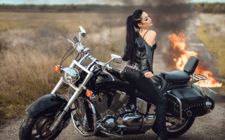 Woman motorcycle fire grass field - a field in the background free wallpaper