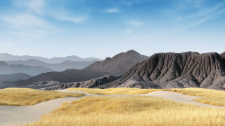 Mountain range grassy field blue 4 - a grassy field in the foreground free wallpaper