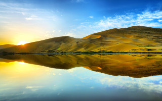 Mountain range lake sun clouds - a lake in the foreground free wallpaper