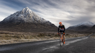 Mountain road bike sunset ocean - peak in the background free wallpaper