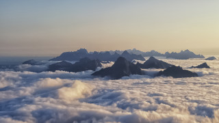 Mountain range clouds sunset cityscape - volumetric fog free wallpaper