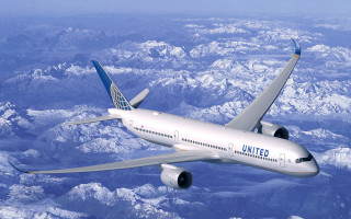 Jetliner flying over mountains blue - a large jetliner free wallpaper for desktop