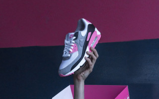 Person holding pink grey shoe - product photo free wallpaper