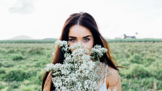 Woman flower field portrait blurry - a woman holding free wallpaper