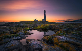 Lighthouse rocky shore sunset pond 3 - a rocky shore free wallpaper