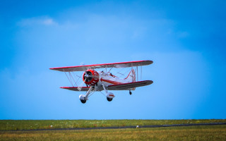 Red white plane flying grass - boleslaw cybi free wallpaper