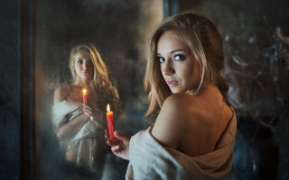 Woman candle mirror reflection background - a woman holding free wallpaper
