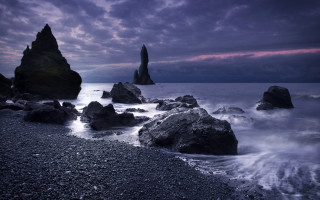 Rocky beach water mountains sky - a cloudy sky free wallpaper