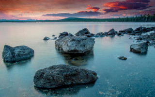 Rocky beach sunset clouds island 2 - the water and a sunset in the background free wallpaper