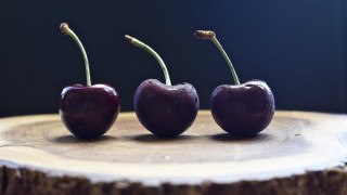 Three cherries on tree stump - top of a tree free wallpaper