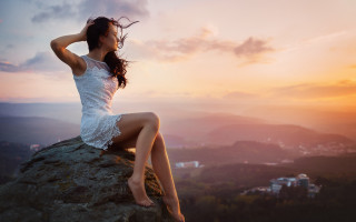 Woman sitting rock wind sunset - daphne mcclure free wallpaper