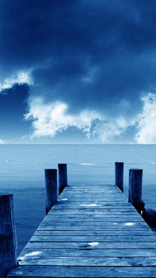 Wooden dock ocean cloudy sky - the ocean under a cloudy sky free wallpaper