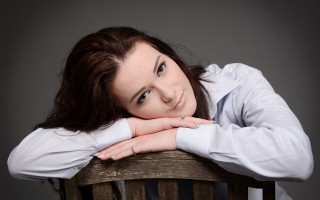 Woman sitting portrait brown hair 2 - her arm free wallpaper