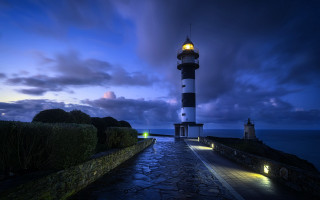 Lighthouse rocky shore night city - a rocky shore free wallpaper