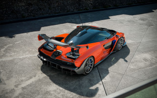 Orange sports car black roof - a concrete surface free wallpaper