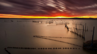Poles sunset ocean clouds hourglass - a sunset in the background free wallpaper