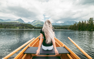 Woman boat lake mountains clouds - cinematic free wallpaper for desktop