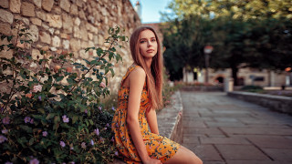 Woman ledge brick wall flowers - a brick wall behind her free wallpaper