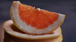 Grapefruit closeup blue black background - redshift free wallpaper