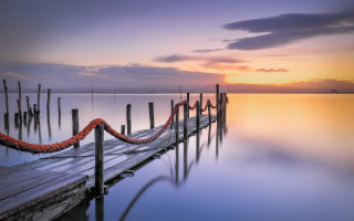 Dock red rope sunset water - a boat in the distance free wallpaper