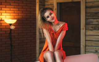 Woman red dress pink couch - a stock photo free wallpaper