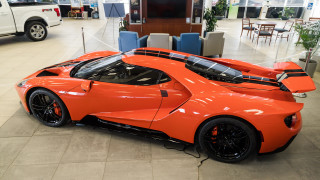 Bright orange sports car showroom 4 - side profile free wallpaper