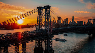 Sunset bridge boat cityscape mountain - the water and a city in the background free wallpaper
