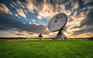 Satellite dish green field cloudy - a lush green field under a cloudy sky free wallpaper