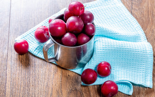 Metal cup cherries wooden table - a blue towel free wallpaper
