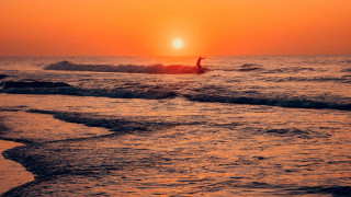 Surfing wave ocean sunset cloudy - the sun setting free wallpaper