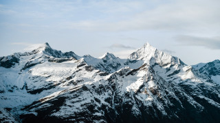 Mountain range snow capped horizon - a mountain range free wallpaper