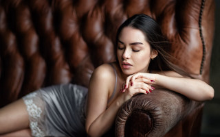 Woman laying couch portrait blurry - a brown couch free wallpaper