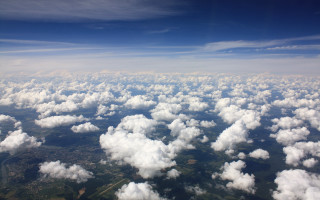 Clouds blue sky mountains ocean - a plane window free wallpaper