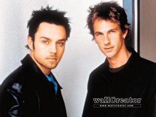 Two men standing room wall 2 - post grunge free wallpaper