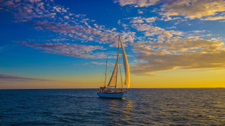 Sailboat ocean sunset clouds people - a sailboat free wallpaper