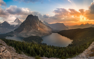 Mountain lake trees sunset clouds 6 - the foreground and a sunset in the background free wallpaper