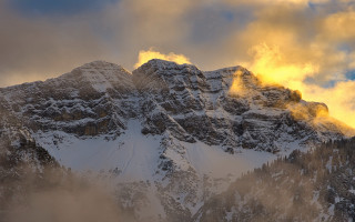 Snowy mountain cloudy sky volumetric - a yellow light free wallpaper