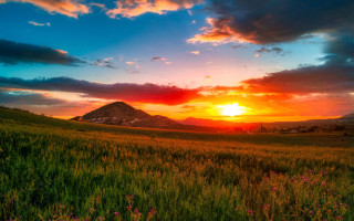 Sunset field mountain clouds horizon - a sunset over a field free wallpaper